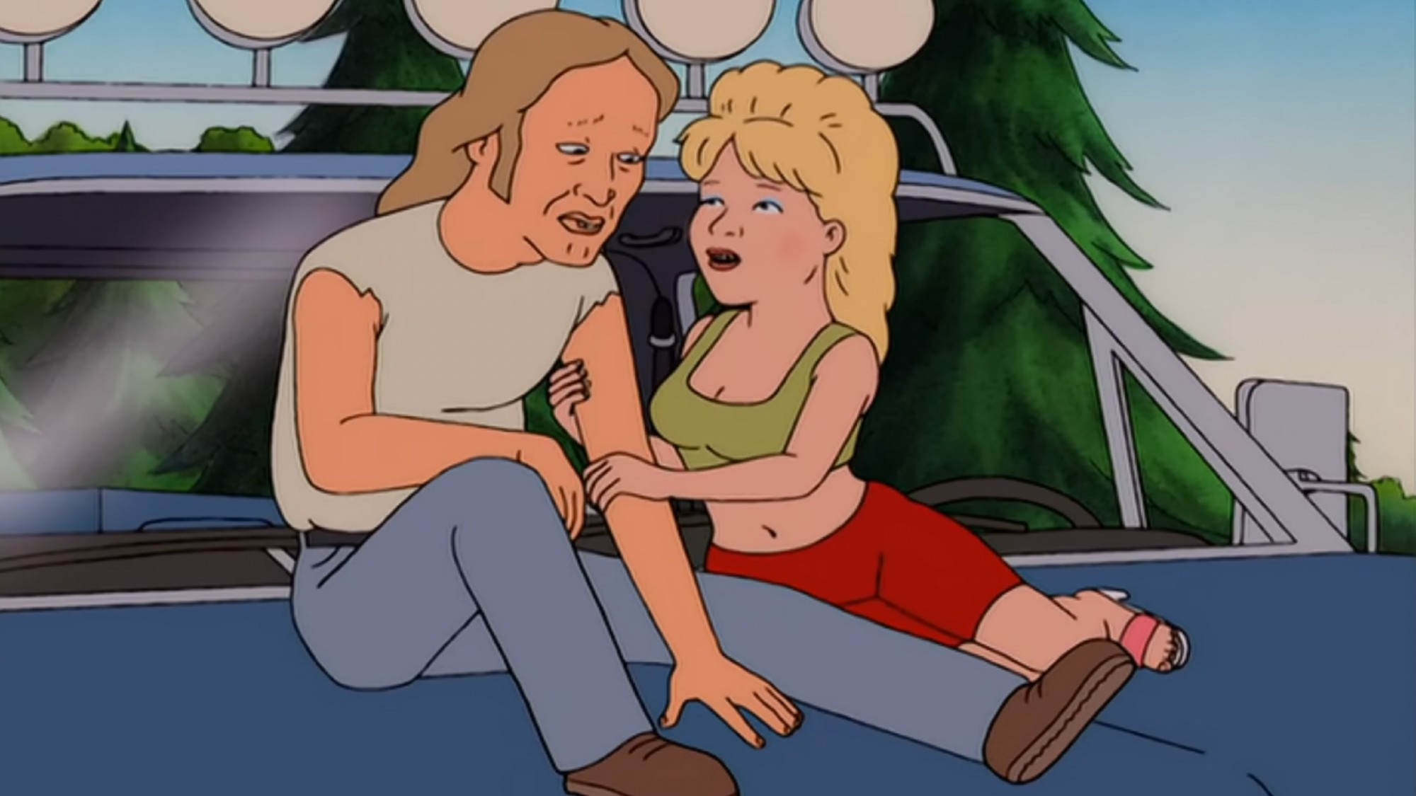 Lucky and Luanne on the hood of a truck.