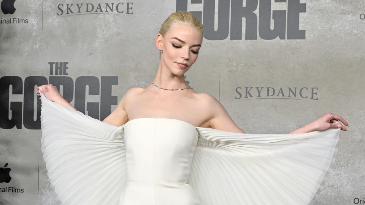 Anya Taylor-Joy wearing a custom dior cape dress with a backwards necklace