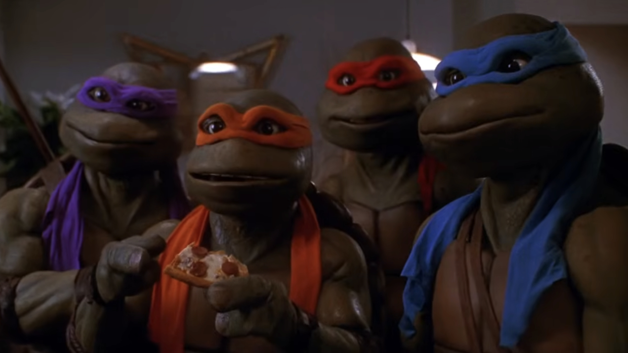 The turtles huddle up in Teenage Mutant Ninja Turtles II: The Secret of the Ooze.