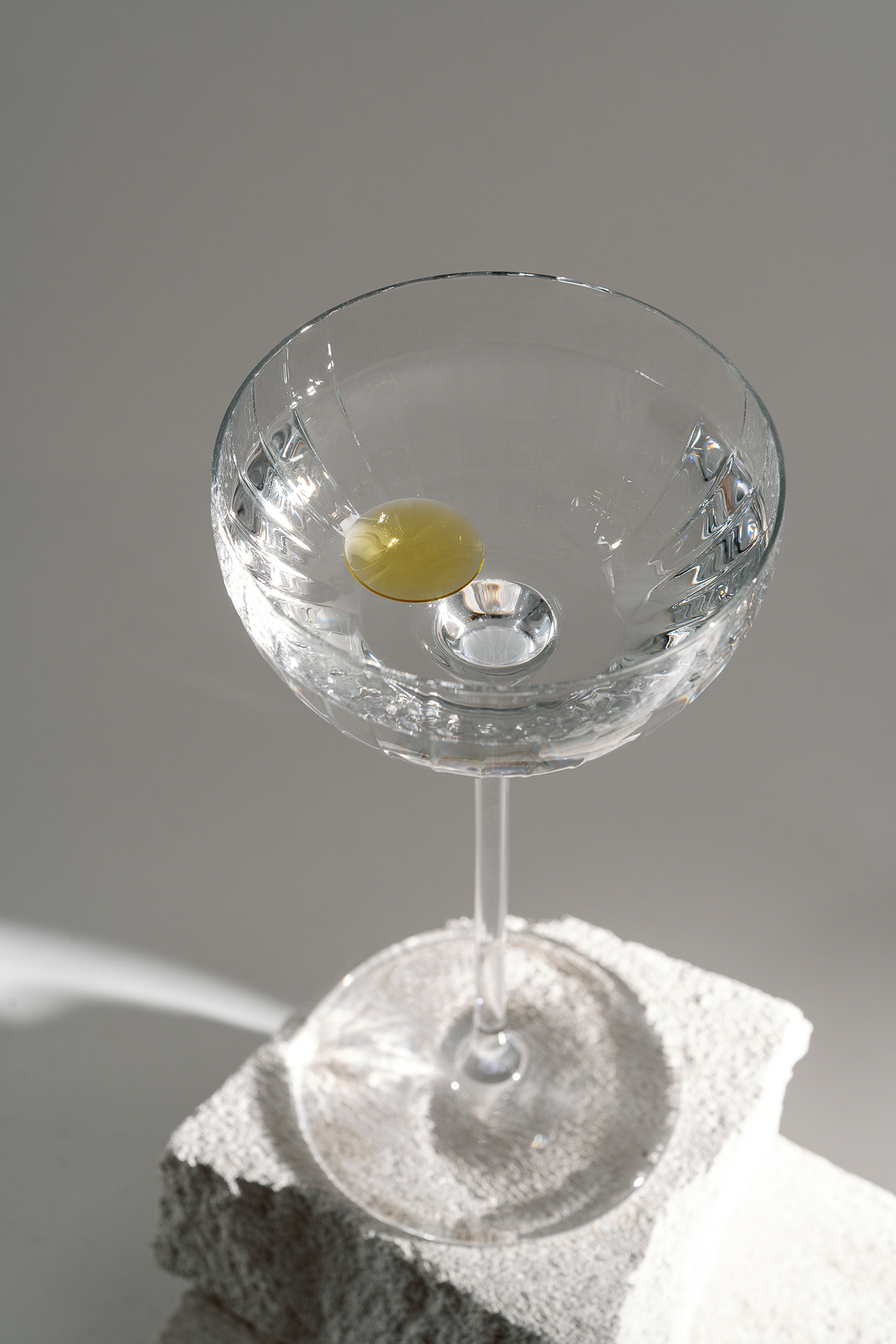 A martini with a drop of olive oil in the top in place of typical garnish