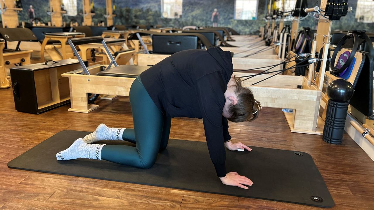 Pilates teacher Juanita Franke demonstrates cat-cow