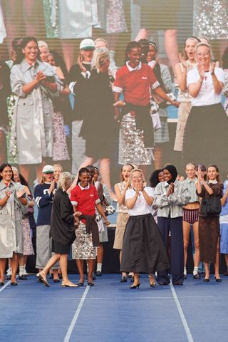 the models for Baum un Pferdgarten's spring 2025 show stand on the track runway with the brand founders while wearing the latest collection shown at Copenhagen Fashion Week