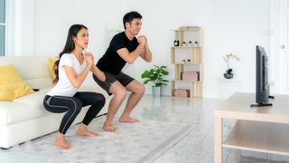 Two people work out at home