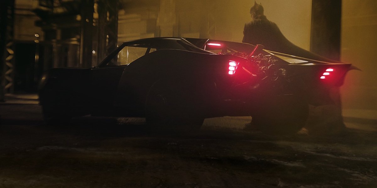 Robert Pattinson&#039;s Batman next to Batmobile