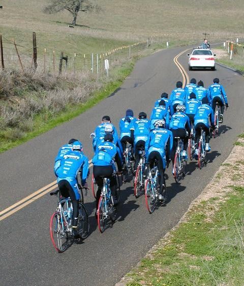 Smile boys! A photographer grabs some riding snaps from the team car