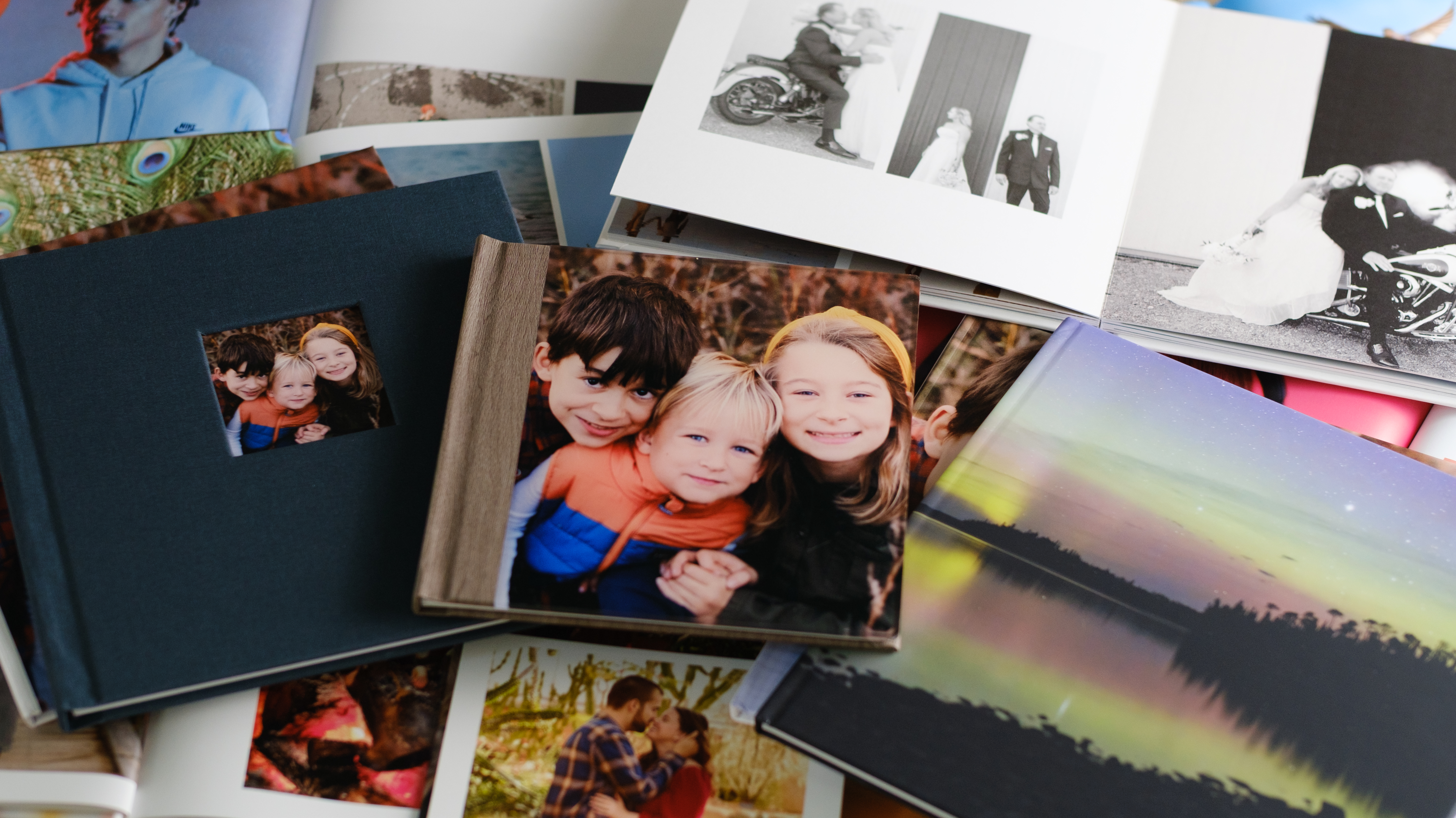 A stack of various photo books on a desk