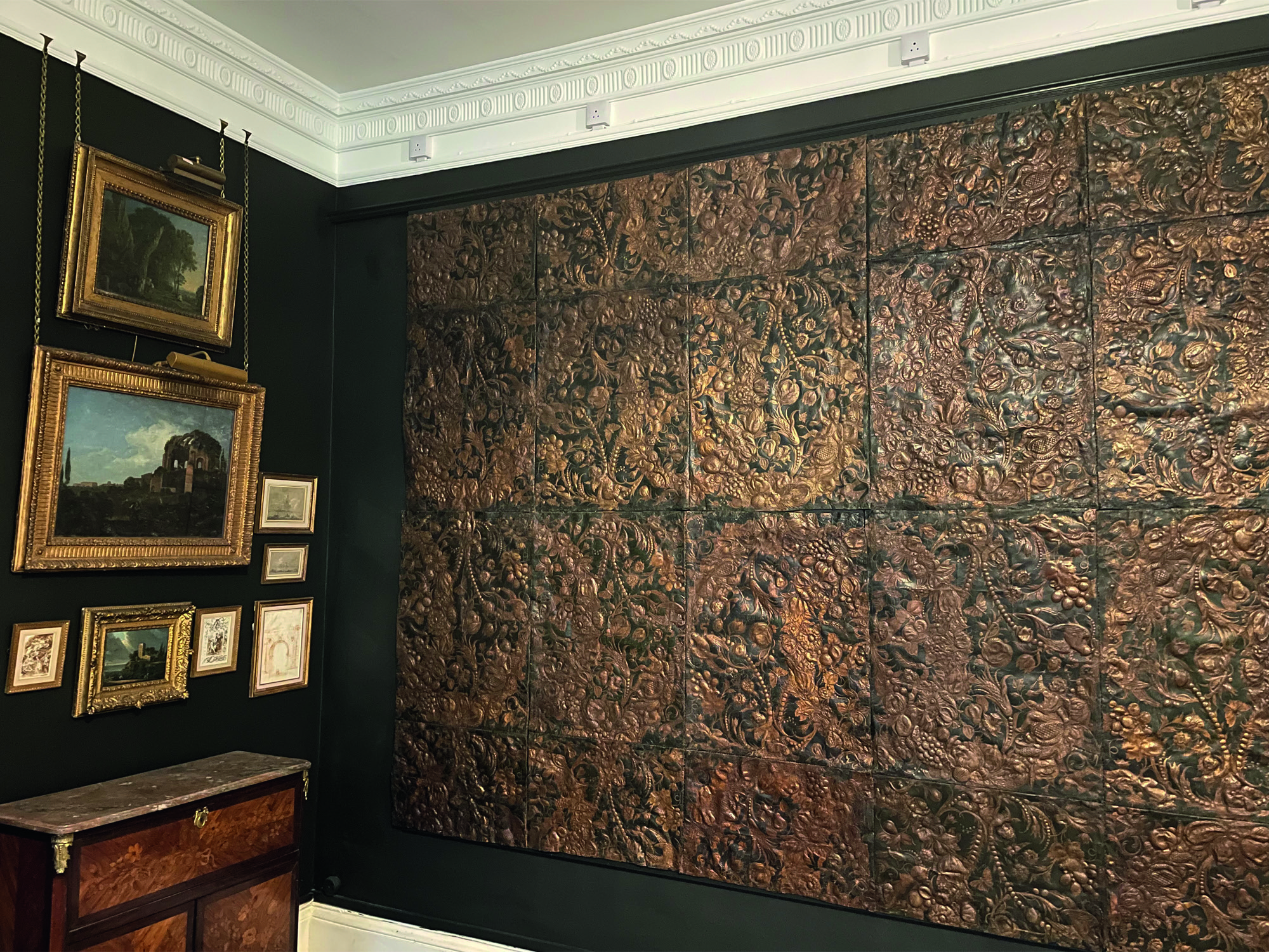 A wall covered in a restored leather collage.