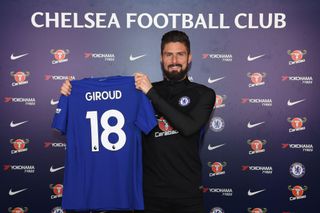 Olivier Giroud of Chelsea holds his new shirt at Chelsea Training Ground on January 31, 2018 in Cobham, England.