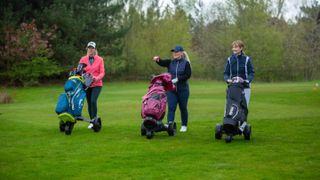 Golfers walking on fairway