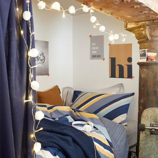 cabin bed area with curtains and fairy lights