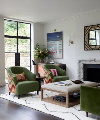 living room with green furniture, coffee table, fireplace, artwork on wall