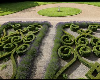 traditional parterre garden design by Richard Miers with box hedging in an ornate pattern and lavender