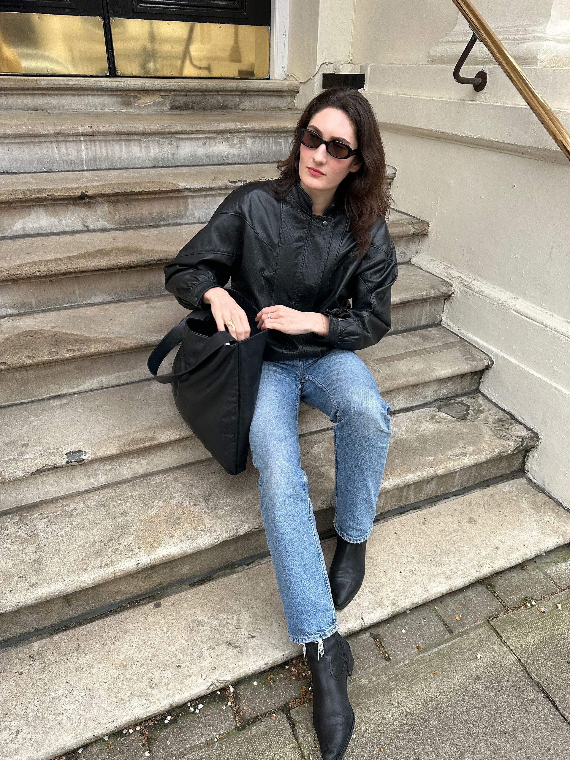 Natalie wears a second hand leather bomber jacket.