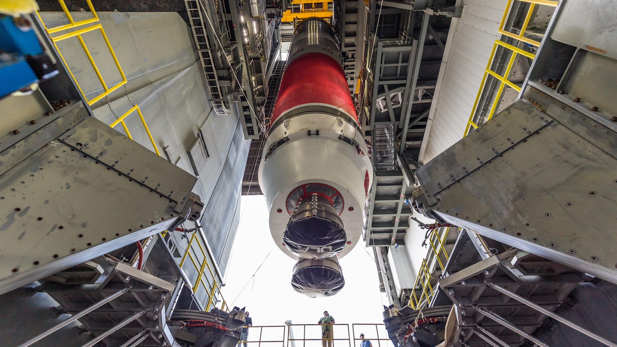 a rocket hangs suspended in an assembly hanger.