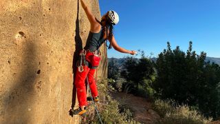 Woman climbing wearing Scarpa Instinct Lace climbing shoes