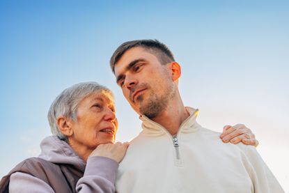 Mature mother and adult son sharing a moment of care and support.