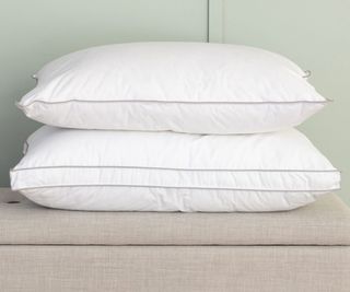 Two plush, white pillows from Soak&leep stacked on top of each other
