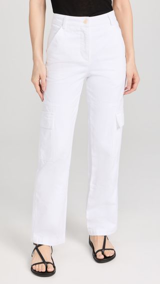a model wears white cargo pants with black sandals