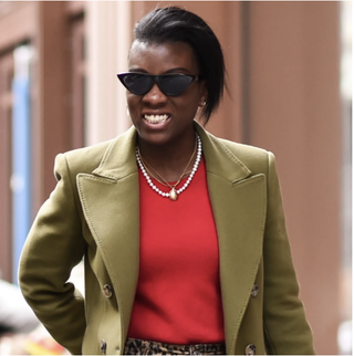 Nikki Ogunnaike wearing a green blazer and a red shirt 