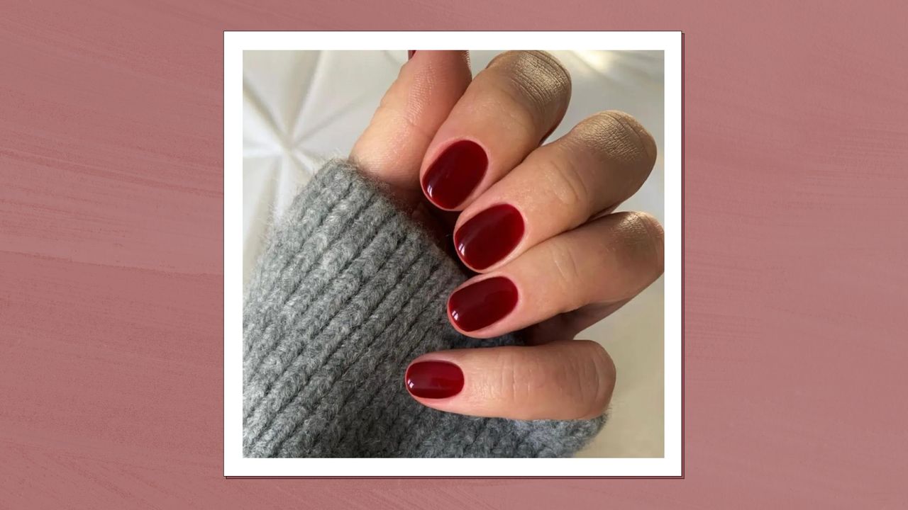 A close up of a hand with burgundy nails by nail artist, @gel.bymegan/ in a dark pink texture template