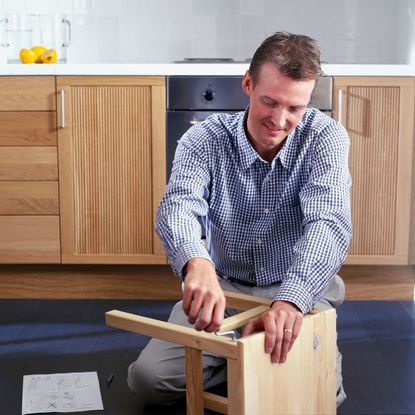 man fixing table