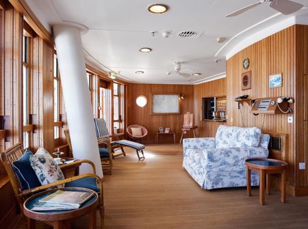 Fig 1: The Sun Lounge. The wall-mounted telephone to the right is identical to those installed in Buckingham Palace. ©Paul Highnam for Country Life