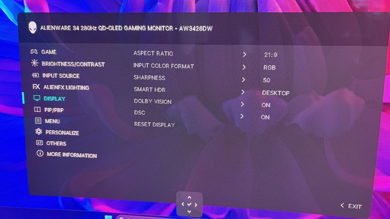 Onscreen menu of an Alienware gaming monitor with options for settings such as brightness, input source, and display configurations against a blue and purple background.