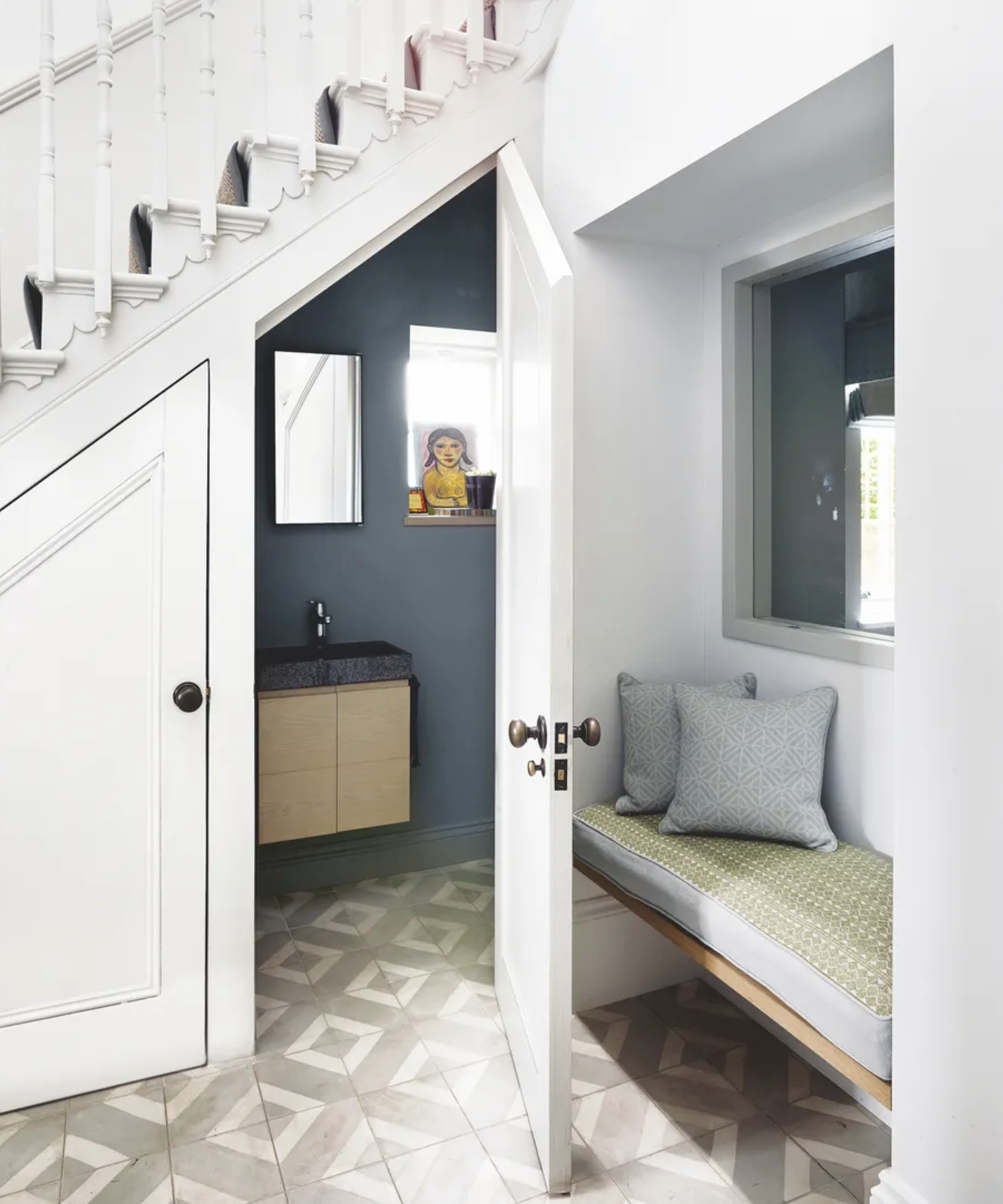 downstairs toilet idea under stairs with patterned tile flooring