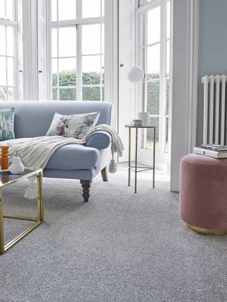 flooring with lilac sofa and footstood