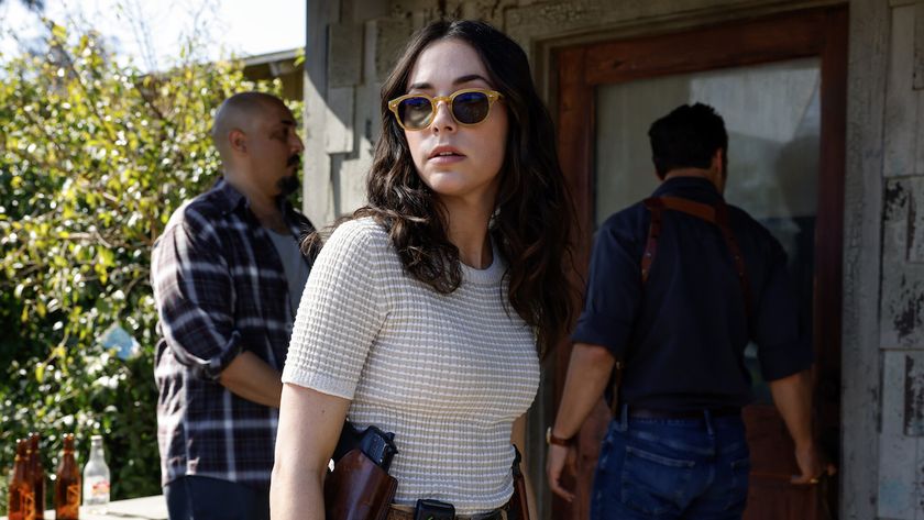 Mariel Molino&#039;s Lala wearing sunglasses and armed while standing near Mike Franks