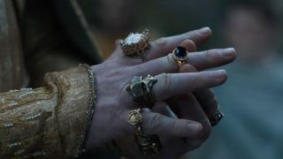 A close-up shot of Gil-galad placing Vilya on his right middle finger in The Rings of Power season 2