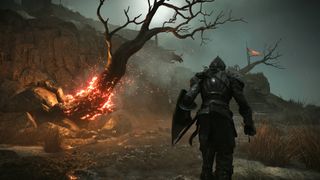 a Knight walks towards a burning tree