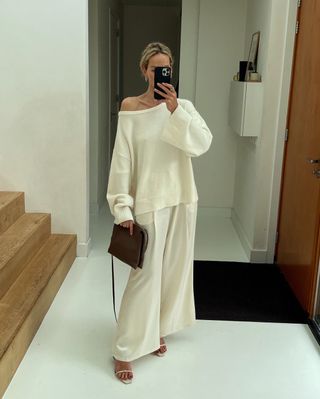 Anouk Yve wearing a cream sweater and cream silk pants