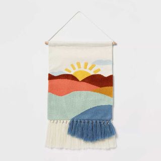 a wall hanging with a sunset 