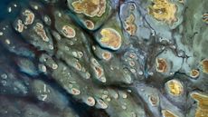 A satellite photo showing dozens of stripy golden islands sitting among shallow water