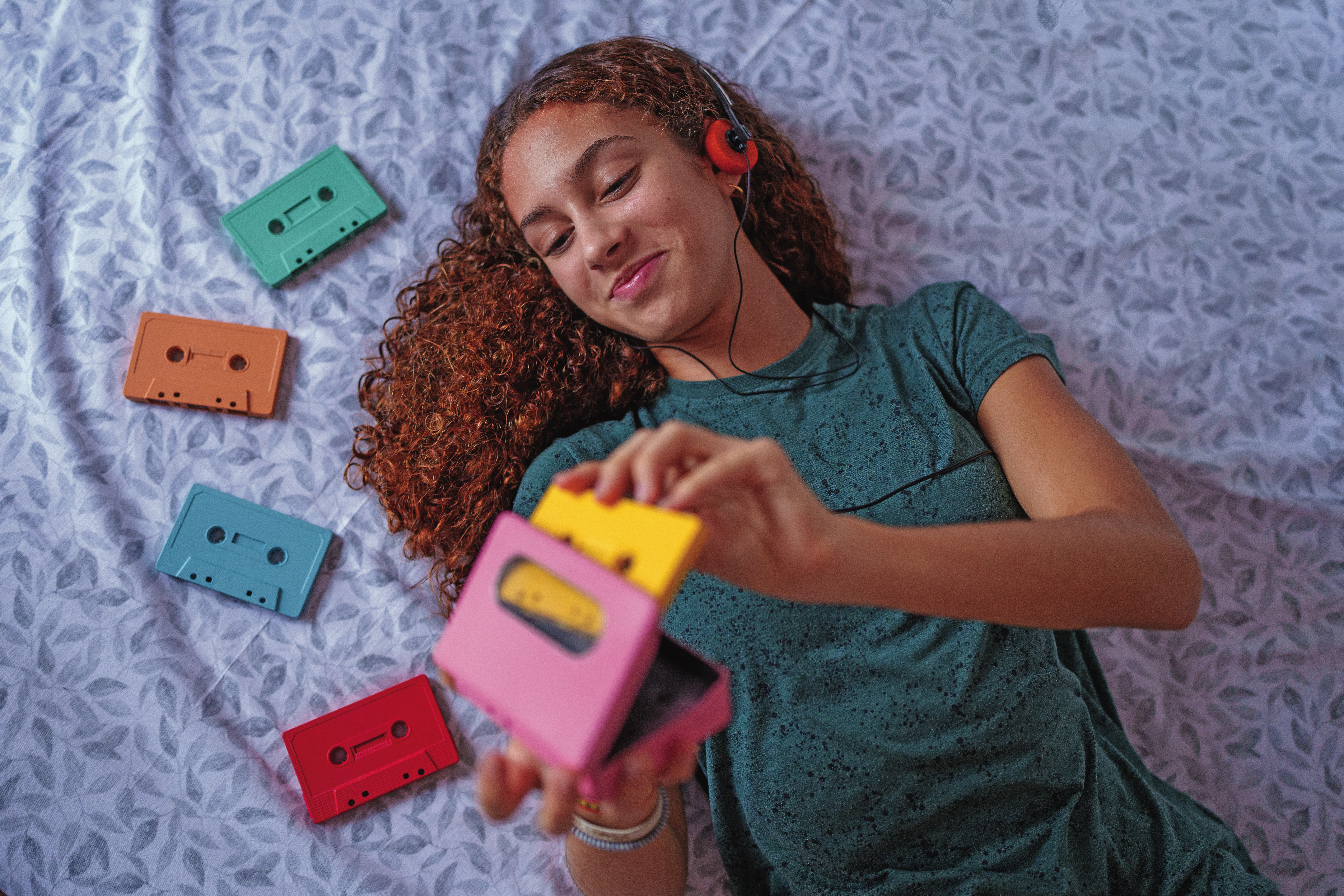 Girl putting a cassette into a case