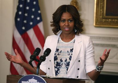 Michelle Obama laments role of money in politics &mdash; then asks donors to write 'a big, fat check'