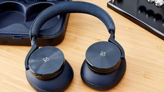 A pair of wireless headphones on a desk