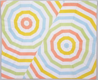 Geometric, concentric pattern in pastel tones, such as one would find on an umbrella