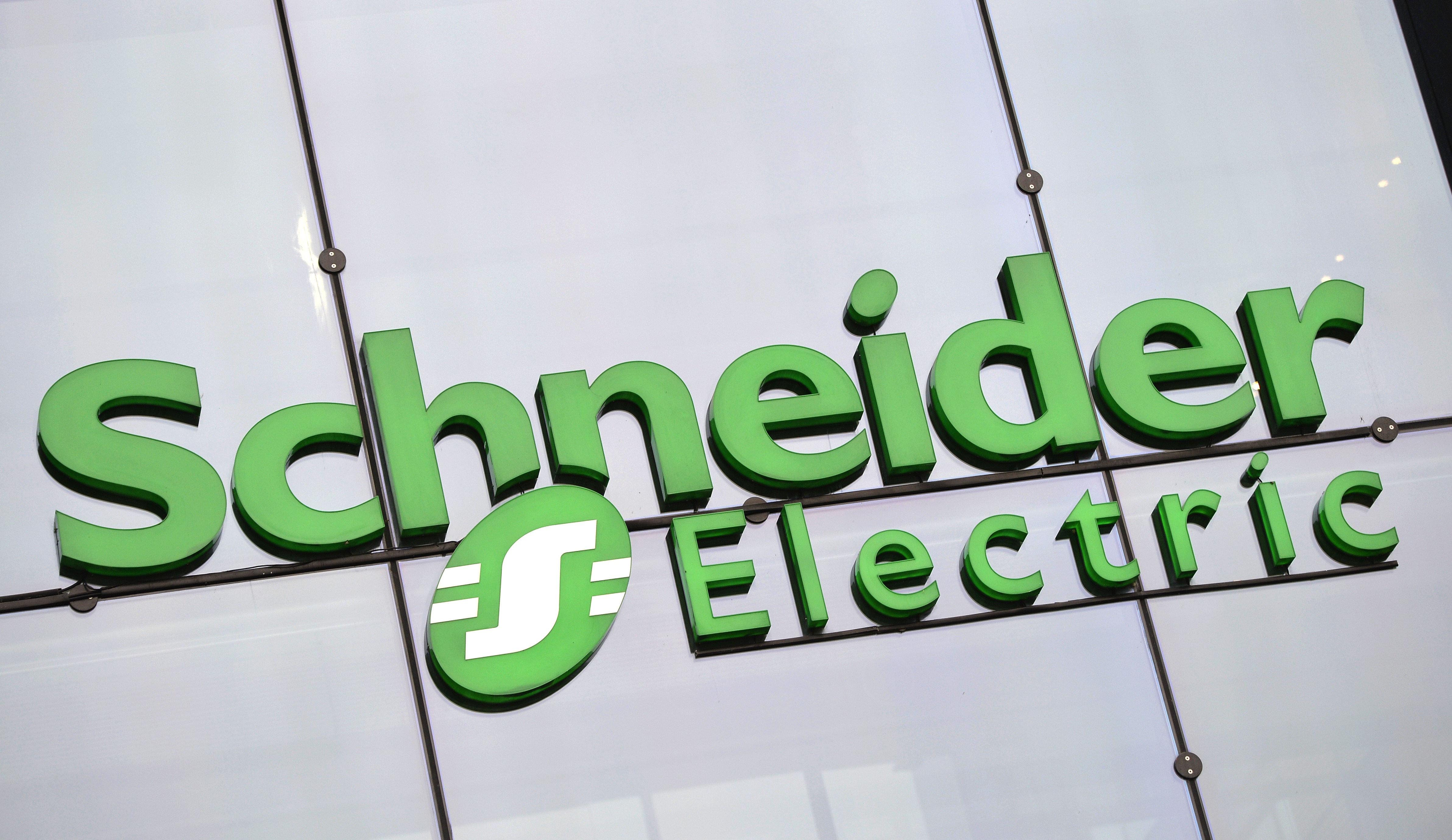 Green Schneider Electric logo outside an office building
