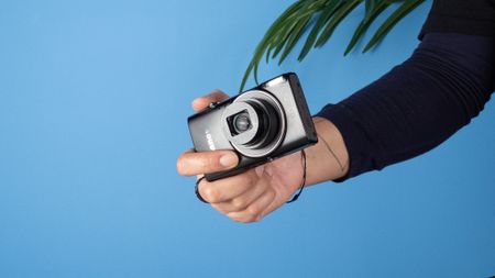 A black Canon PowerShot Elph 360 HS A or Canon PowerShot IXUS 285 HS A compact camera