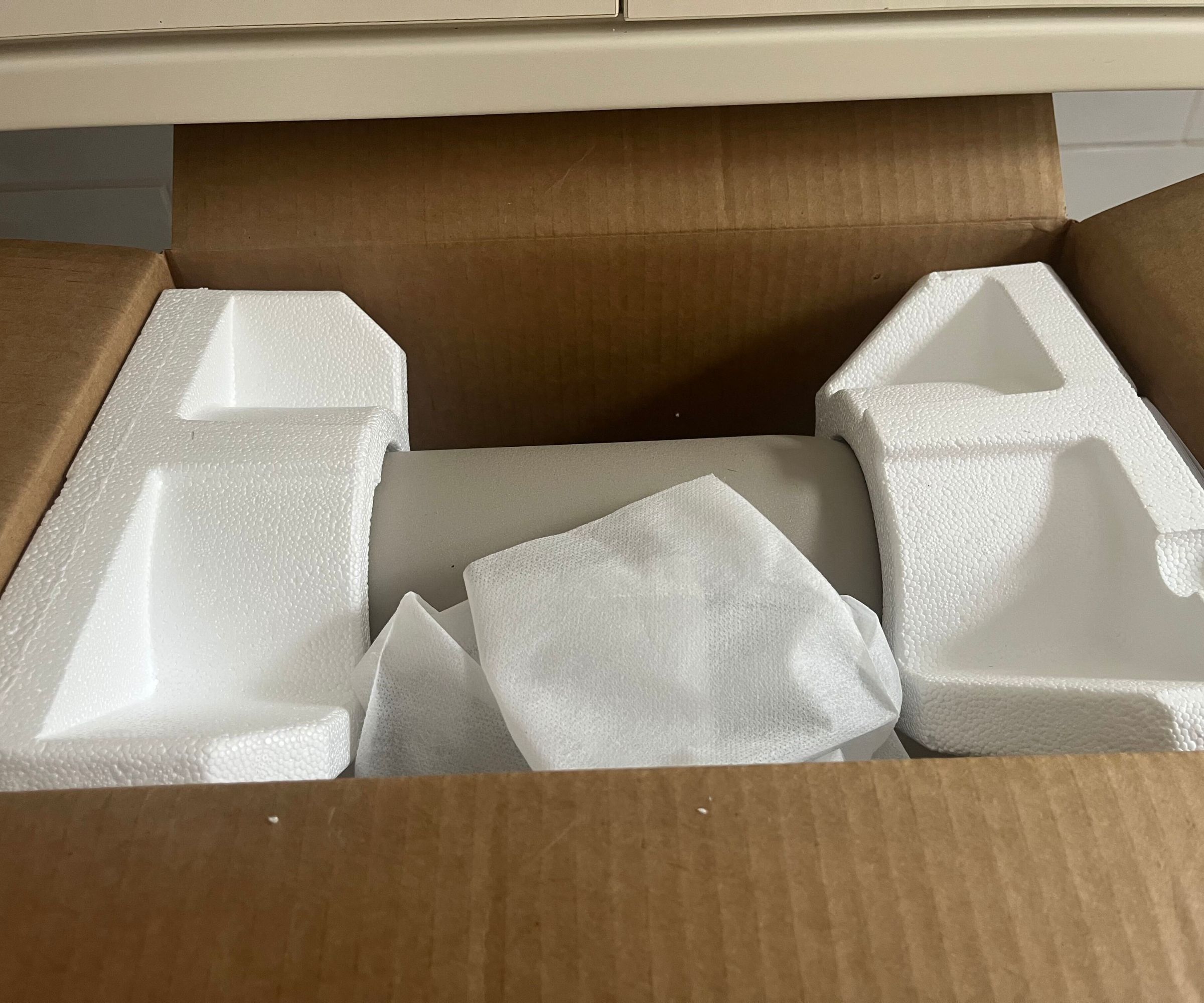 A top view of the styrofoam packaging in the brown KitchenAid Artisan Plus Stand Mixer