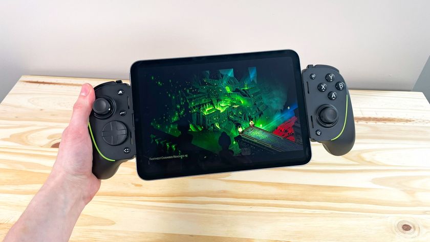 A hand holding up the iPad Mini 7 connected to the Razer Kishi Ultra controller running Hades