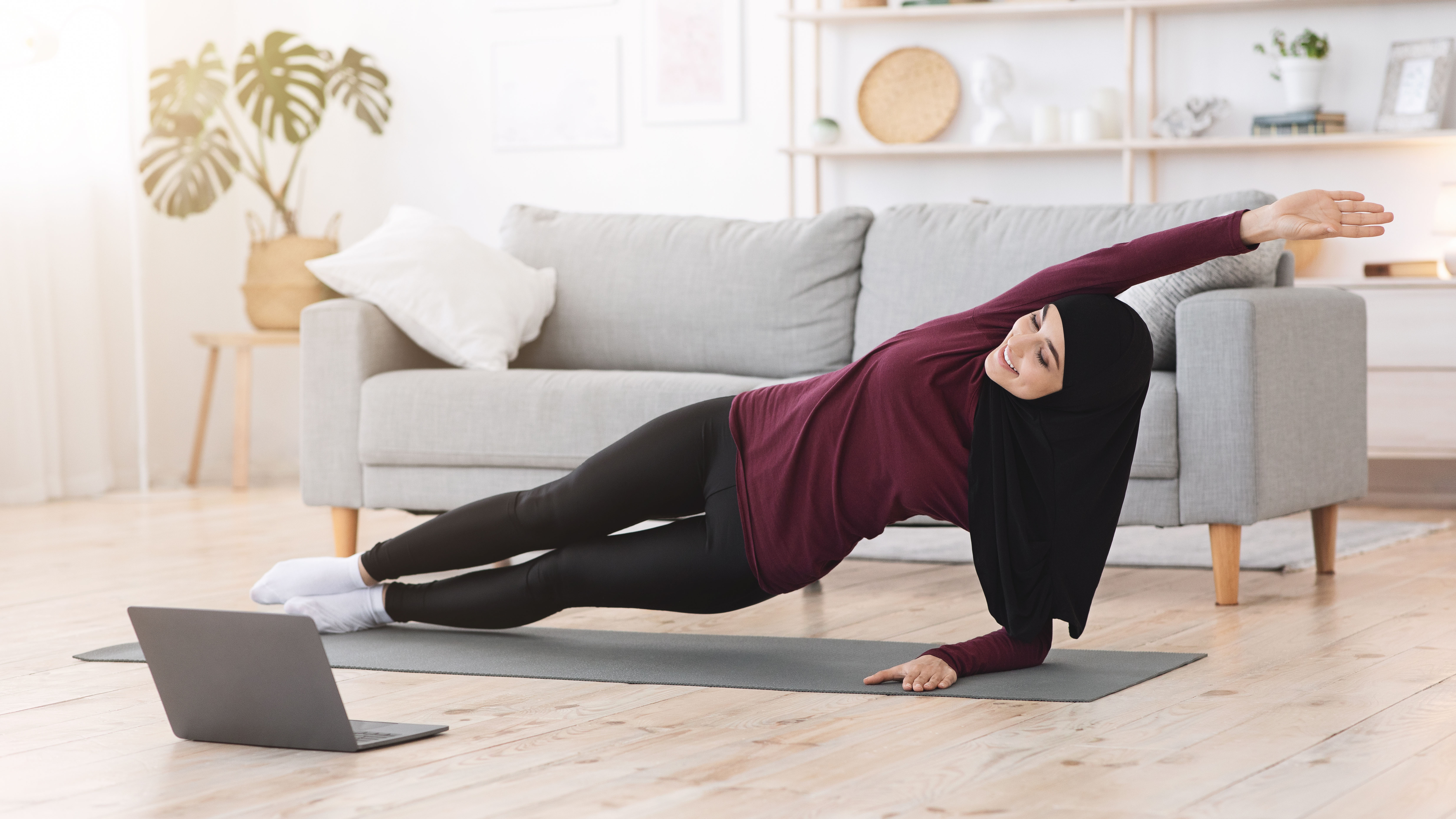 Woman doing side plank at home
