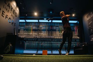 A golfer using the fittings bays at PXG london south