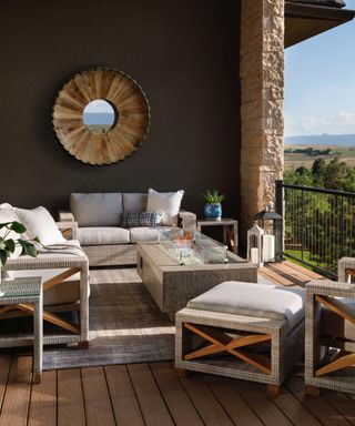 how to make a patio look expensive on a budget, patio with furniture, rug, round mirror, firepit, view of yard