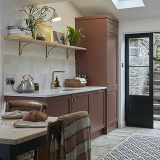 brown kitchen with door to garden