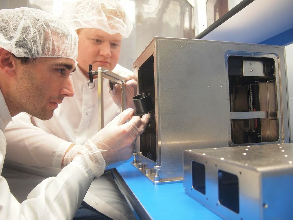 Mike Snyder (right) and Jason Dunn of Made In Space get the company&#039;s 3D printer ready for its September 2014 launch toward the International Space Station. The machine printed its first part in orbit on Nov. 24, 2014. 