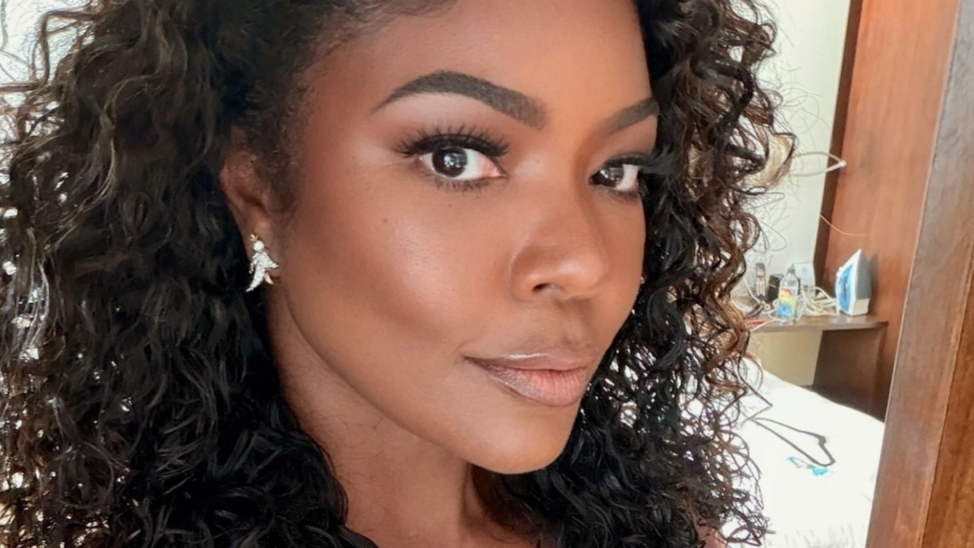 Gabrielle Union wears a long sleeved pink Zuhair Murad fall 2026 dress to Coco Jones's wedding. 
