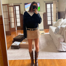 woman wearing black sweater and mini skirt